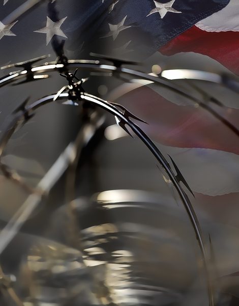 USA Border fence barb razor wire and American Flag Immigration Concept photograph