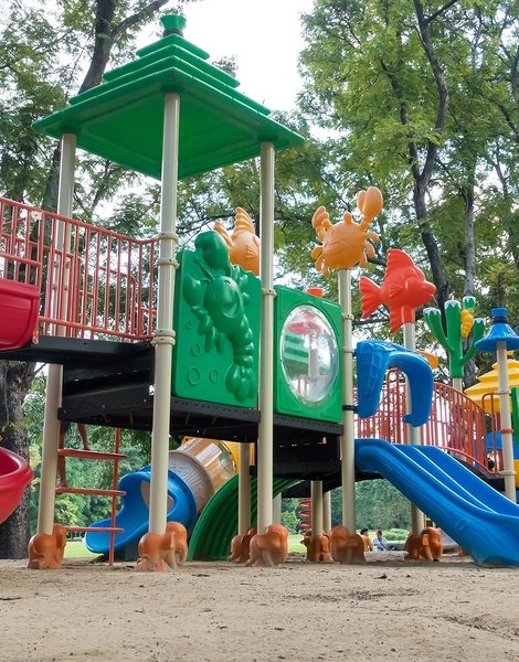 Colorful playground with children and parents in park