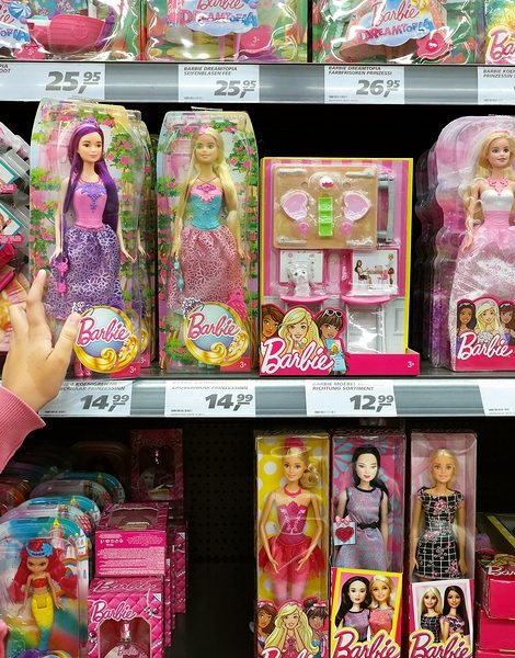 GERMANY - AUGUST 12, 2017: Shopping girl and Toy dolls in a store. Barbie is a fashion doll manufactured by the American toy company Mattel