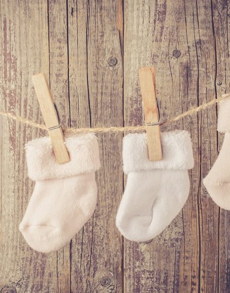 Baby socks hanging on twine. Close up