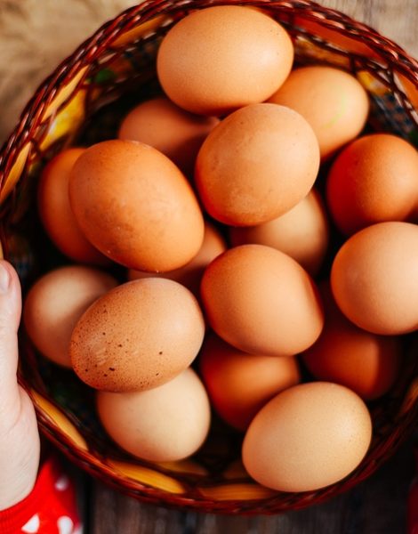 Close up of eggs in a basket. top view of eggs in bowl. Brown eggs in wooden bowl. Chicken Egg. Hen eggs baske
