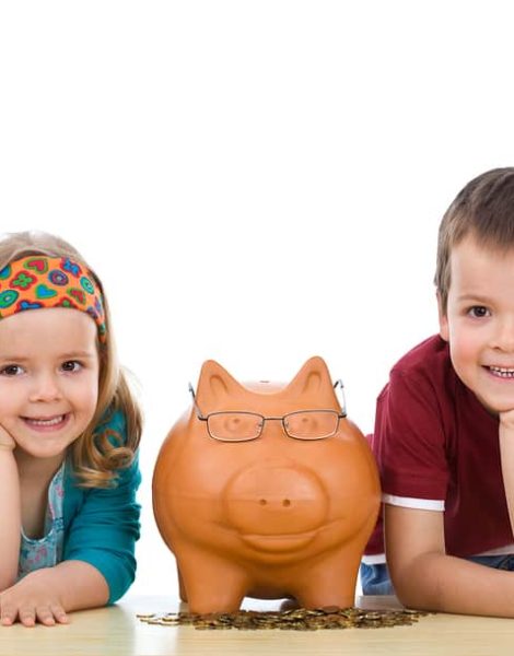 Kids with their expert piggy bank - financial education concept isolated