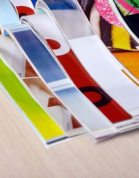 Magazines on wooden table close up