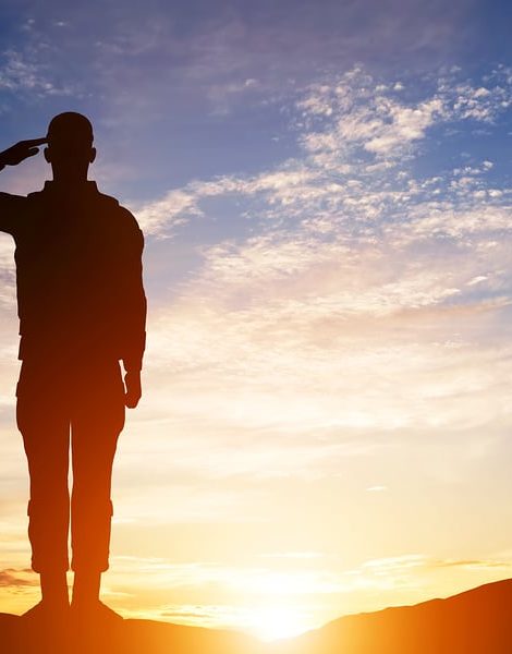 Soldier salute. Silhouette on sunset sky. War, army, military, guard concept.