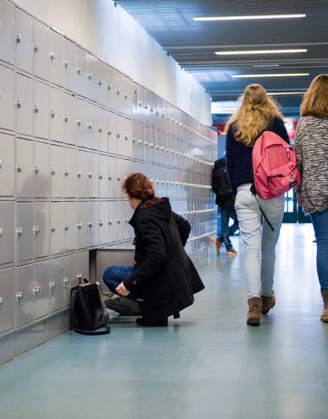 ENSCHEDE THE NETHERLANDS - 02 FEB 2015: Students are walking through a hallway with lockers on a high school