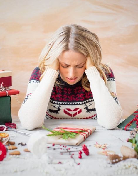 Beautiful woman depressed with Christmas gift clutter