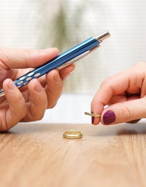 Husband is giving pen to sign divorce papers his former wife after he take off the ring form finger